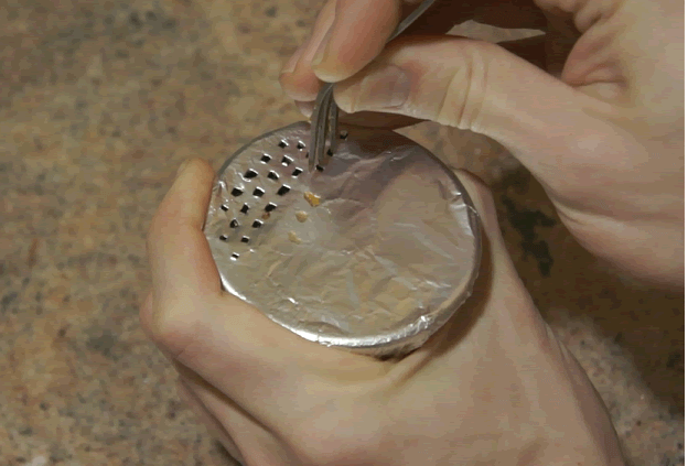 Poking holes in a hookah bowl using a fork