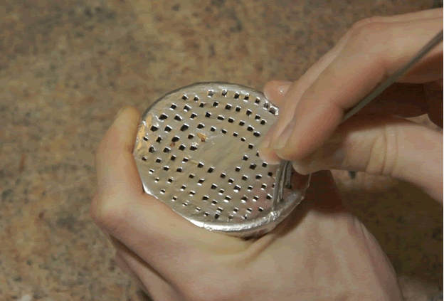 Poking holes in a hookah bowl using a fork